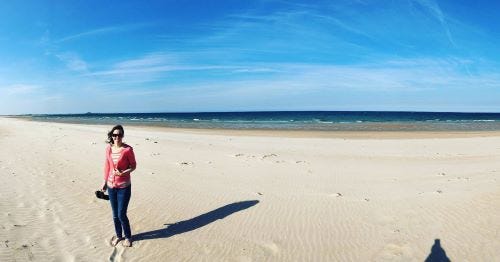 woman standing on sandy beach