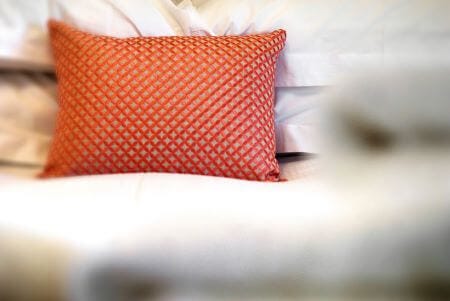 Colourful pillow on the bed