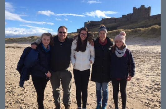 family behind bamburgh beach house