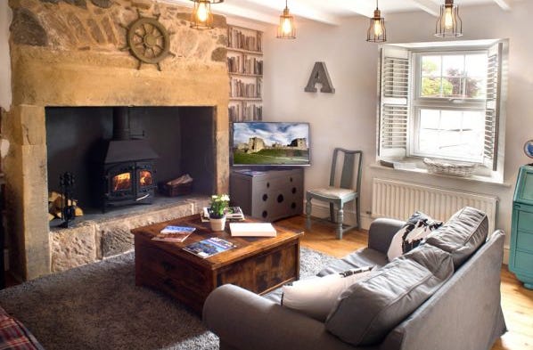 cosy living room with lit woodburner