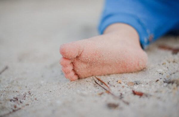 babies feet in the sand